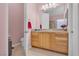 Elegant bathroom featuring a wooden cabinet with sink and a decorative window for added charm at 2554 Braehead Ln, Henderson, NV 89044