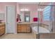 Elegant bathroom with a soaking tub, separate glass-enclosed shower, and dual vanities at 2554 Braehead Ln, Henderson, NV 89044