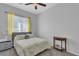 Comfortable bedroom with a ceiling fan, neutral walls, and a sunlit window at 2554 Braehead Ln, Henderson, NV 89044