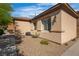 Home exterior with a well-maintained lawn and decorative rock landscape at 2554 Braehead Ln, Henderson, NV 89044