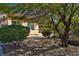 Home exterior with lush landscaping, a tree, and a well-maintained lawn at 2554 Braehead Ln, Henderson, NV 89044