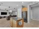 Open concept kitchen and living room area featuring granite island and stainless steel appliances at 2554 Braehead Ln, Henderson, NV 89044