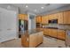Kitchen with wood cabinets, stainless appliances, granite counters, and an island at 2554 Braehead Ln, Henderson, NV 89044