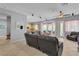 Open concept living room with tile floors, a fan, and lots of natural light at 2554 Braehead Ln, Henderson, NV 89044