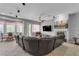 Spacious living room with a bay window, fan, and a cozy fireplace at 2554 Braehead Ln, Henderson, NV 89044