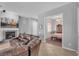Living room featuring a fireplace, dining room, and comfortable leather furniture at 2554 Braehead Ln, Henderson, NV 89044