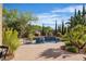 Beautiful pool area with landscaping featuring a tanning ledge and mature shade trees at 2554 Braehead Ln, Henderson, NV 89044