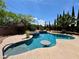 Inviting pool and spa featuring a swim up table surrounded by lush landscaping at 2554 Braehead Ln, Henderson, NV 89044