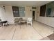 Covered back porch featuring a patio table and chairs on a concrete floor at 2571 Swans Chance Ave, Henderson, NV 89052
