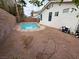 Backyard featuring a kidney shaped pool and red gravel at 2571 Swans Chance Ave, Henderson, NV 89052