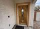 Close-up of a stylish wood front door with decorative glass, offering a warm welcome to the home at 2571 Swans Chance Ave, Henderson, NV 89052