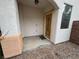 Inviting front porch with a detailed wooden door and textured peach and tan posts at 2571 Swans Chance Ave, Henderson, NV 89052