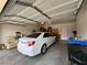 Spacious two-car garage with ample storage space, currently housing a sedan and other household items at 2571 Swans Chance Ave, Henderson, NV 89052