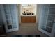 Hallway with french doors leading to an open living space and built in cabinet at 2571 Swans Chance Ave, Henderson, NV 89052