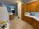Kitchen with brick tile flooring, wooden cabinets, and view into living room at 2571 Swans Chance Ave, Henderson, NV 89052