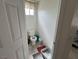 Small toilet room with cleaning supplies, an open door, and tile floor at 2571 Swans Chance Ave, Henderson, NV 89052