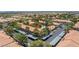 Community with multiple buildings, covered parking, swimming pool, and lush greenery from an aerial view at 2606 S Durango Dr # 260, Las Vegas, NV 89117