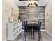 Chic dining area featuring a rustic wood accent wall and modern black dining set at 2606 S Durango Dr # 260, Las Vegas, NV 89117