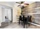 Stylish dining area with a rustic wood accent wall and black dining table at 2606 S Durango Dr # 260, Las Vegas, NV 89117