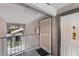 View of the hallway with a decorated door, iron railing, and an archway to the outside at 2606 S Durango Dr # 260, Las Vegas, NV 89117