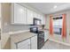 Functional kitchen with white cabinetry, black appliances, and plenty of natural light at 2606 S Durango Dr # 260, Las Vegas, NV 89117