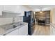 Efficient kitchen featuring white cabinets, stainless steel appliances, and an adjacent dining area at 2606 S Durango Dr # 260, Las Vegas, NV 89117