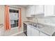 Galley kitchen featuring stainless steel dishwasher, sink and white cabinets at 2606 S Durango Dr # 260, Las Vegas, NV 89117
