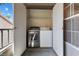 Convenient laundry closet with a stacked washer and dryer setup, accessible from outside at 2606 S Durango Dr # 260, Las Vegas, NV 89117
