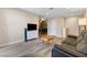 Open-concept living room featuring a comfortable gray sofa, TV, and dining area in the background at 2606 S Durango Dr # 260, Las Vegas, NV 89117
