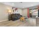 Comfortable living room with a plush gray sofa, wooden coffee table, and sliding glass doors at 2606 S Durango Dr # 260, Las Vegas, NV 89117