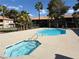 Sparkling community pool and jacuzzi offer a refreshing escape surrounded by lush landscaping and sunny skies at 2606 S Durango Dr # 260, Las Vegas, NV 89117