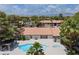 Aerial view of the community pool and hot tub, surrounded by lush landscaping and palm trees at 2606 S Durango Dr # 260, Las Vegas, NV 89117