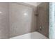 Close-up of a tile shower showing the shower head, faucet, and corner shelf at 2606 S Durango Dr # 260, Las Vegas, NV 89117