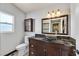 Bathroom features a vessel sink, granite counters, and a decorative mirror at 2805 El Cubano Ct, North Las Vegas, NV 89030