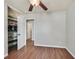 Bedroom with wood floors, ceiling fan, and closet with shelving at 2805 El Cubano Ct, North Las Vegas, NV 89030