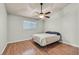 This bedroom features a ceiling fan, wood floors, and a window at 2805 El Cubano Ct, North Las Vegas, NV 89030
