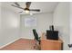 Bedroom featuring wood floors, ceiling fan, and desk area at 2805 El Cubano Ct, North Las Vegas, NV 89030