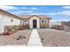 Inviting single-story home with decorative accents and manicured desert front yard at 2805 El Cubano Ct, North Las Vegas, NV 89030
