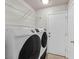 This laundry room features a washer and dryer hookup and storage shelves at 2805 El Cubano Ct, North Las Vegas, NV 89030