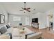 Bright living room with hardwood floors, ceiling fan, and a neutral color palette at 2805 El Cubano Ct, North Las Vegas, NV 89030