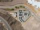 Bird's eye view of a modern home with solar panels, pool, meticulous landscaping, and curved access road at 3 Horseshoe Rock Ct, Henderson, NV 89012