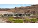 Expansive aerial view of a modern residence showcasing its architectural design and desert surroundings at 3 Horseshoe Rock Ct, Henderson, NV 89012