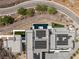Aerial view of a luxury home featuring solar panels, a pool, modern design, and desert surroundings at 3 Horseshoe Rock Ct, Henderson, NV 89012