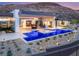Backyard with a modern pool, hot tub, bar, and desert landscaping, perfect for entertaining at 3 Horseshoe Rock Ct, Henderson, NV 89012