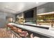 Modern bar area with marble countertop, stylish seating, and decorative shelving perfect for entertaining guests at 3 Horseshoe Rock Ct, Henderson, NV 89012