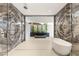 Luxurious bathroom featuring a soaking tub, glass shower, and access to a private outdoor patio at 3 Horseshoe Rock Ct, Henderson, NV 89012