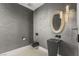 Modern powder room featuring grey color palette, vessel sink and geometric mirror at 3 Horseshoe Rock Ct, Henderson, NV 89012
