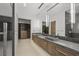 Bright bathroom featuring a double vanity with vessel sinks, wood cabinets, and a glass-enclosed shower at 3 Horseshoe Rock Ct, Henderson, NV 89012