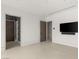 Minimalist bedroom with neutral walls, a large television, and tile floors at 3 Horseshoe Rock Ct, Henderson, NV 89012