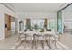 Modern dining room featuring a spacious table and chairs set on a stylish rug, with kitchen views at 3 Horseshoe Rock Ct, Henderson, NV 89012